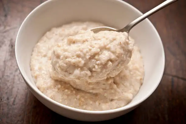 bowl of Oatmeal ( Porridge ) from above with spoon.