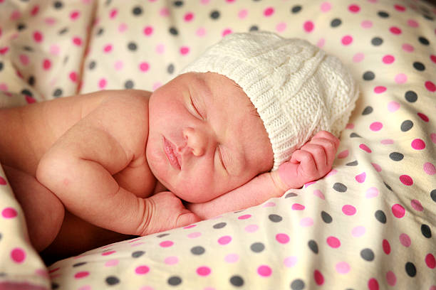 istock Modern Newborn Baby in White Knit Hat 182440290