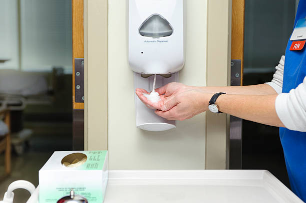Using hand sanitizer A nurse using hand sanitizer before entering patients' rooms.Need more medical imagery Check out my hygiene stock pictures, royalty-free photos & images