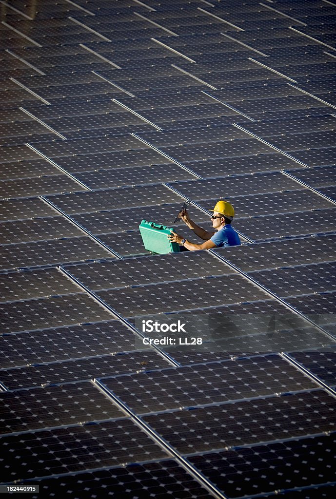 Testing at a solar farm Image of a worker doing testing at a photovoltaic farm (ISO 100). All my images have been processed in 16 Bits and transfer down to 8 before uploading. Blue-collar Worker Stock Photo