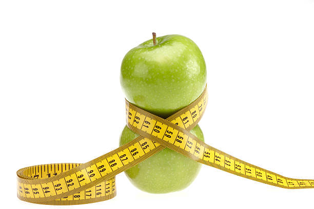 istock Green apples with centimeter tape measure 182441004
