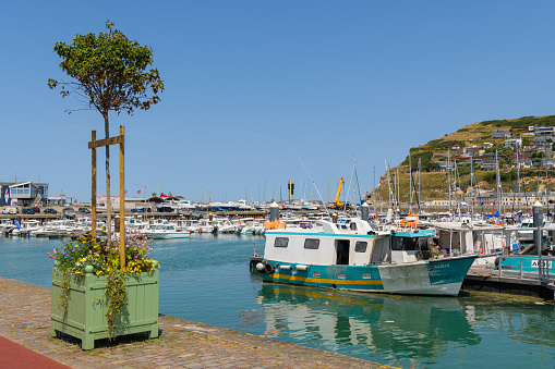 Fecamp, France - July 17, 2022: The harbor of Fecamp on a calm sunny day in summer, blue sky