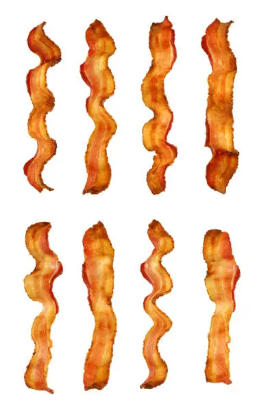 High resolution digital capture of eight strips of crispy, smokey, delicious bacon, precision isolated and set on a background of pure white with no shadows. Each strip is shot from a slightly different angle and there are no burnt spots.