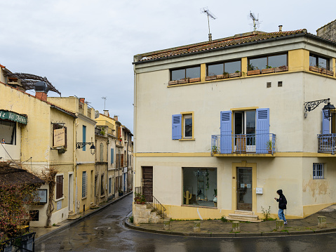 Rome, Italy, June 01 -- An Italian flag waving between the windows and balconies of an ancient palace in Piazza Navona, one of the most loved and visited places in Rome by tourists. Image in High Definition format.