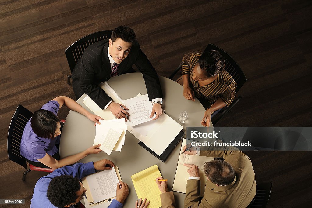 Five People Meeting Five co workers are sitting around a table having a group meeting. They are of different races and ages.More like this: Business Meeting Stock Photo