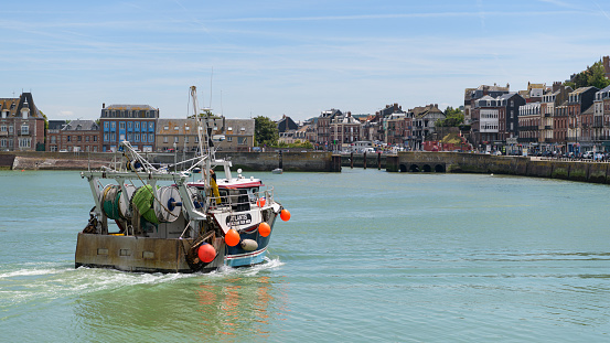 Le Treport, France - July 17, 2022: A fisherboat in the harbor of Treport on a sunny day in summer