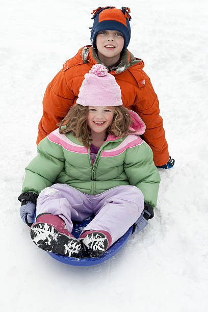 istock Boy and girl sledding 182442209