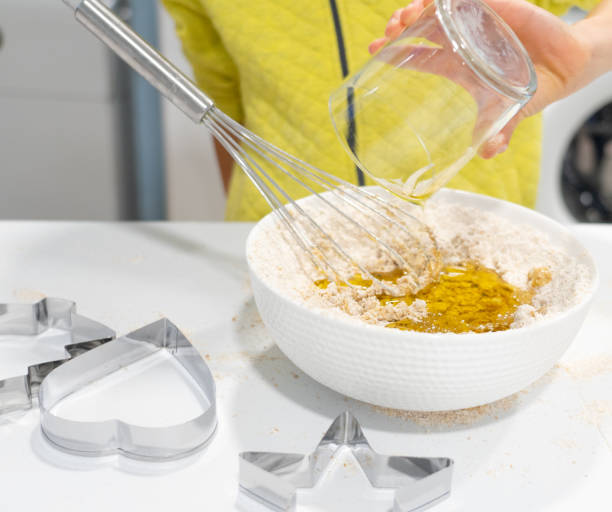 istock Child preparing a homemade dough in a bowl 1824422430