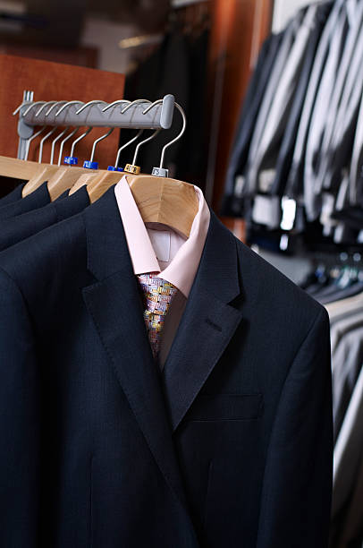 istock mens suits hanging in shop 182442371