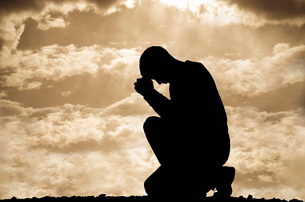 istock Sepia Prayer Silhouette 182442453
