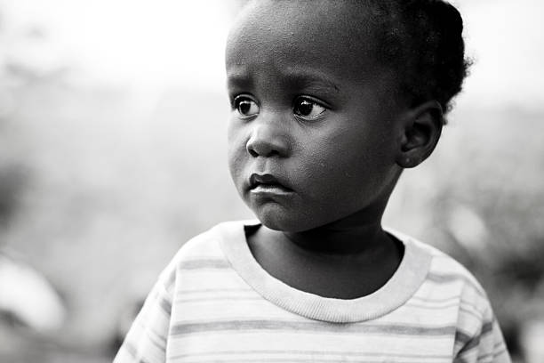A little African girl looking to the side.