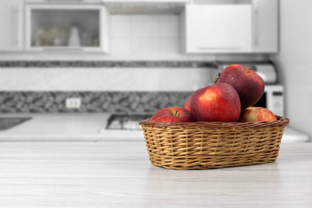istock Red apples in a wicker basket on the kitchen table. 1824428308