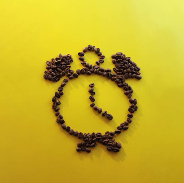 coffee alarm clock on a yellow background, cheerfulness
