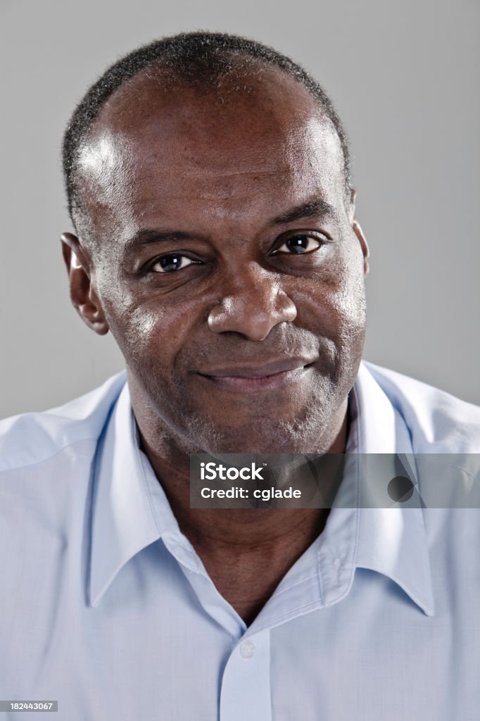 Man smiling for camera on gray background Sincere African American male 50-59 Years Stock Photo