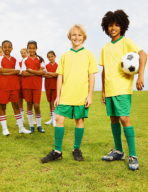 istock Football players with their rival team at the back 182443704