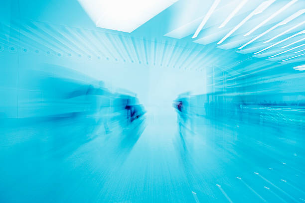 istock People Walking in Modern Interior, Zoom Blur, Blue Toned Image 182443803