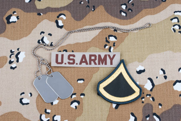 istock US ARMY Private First Class rank patch and dog tags on Desert Battle Dress Uniform 1824449321