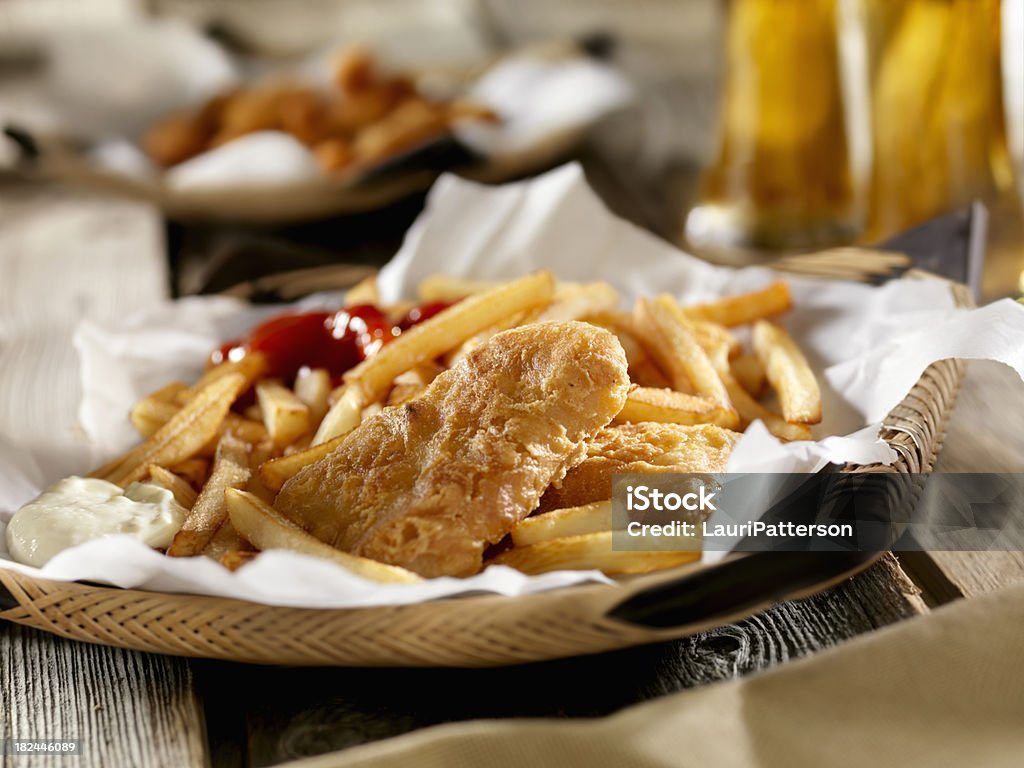 Fish and Chips with a Beer Fish and Chips and a Beer -Photographed on Hasselblad H3D2-39mb Camera Fish and Chips Stock Photo