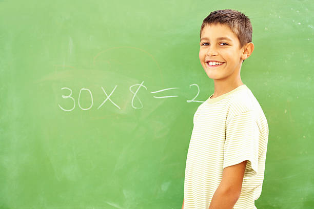 istock Small school boy smiling by the board 182447013
