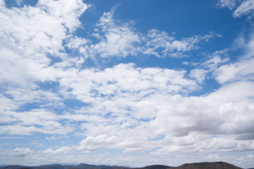 large clouds of different shapes against a blue sky background. High quality photo