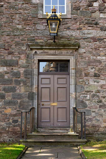 Old Georgian stone townhouse door with fanlight window above door.