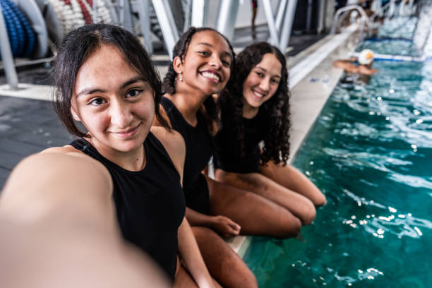 Friends taking a selfie during swimming class - camera point of view