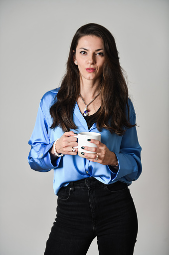 Cute Female In Blue Shirt Holding A Cup Of Coffee