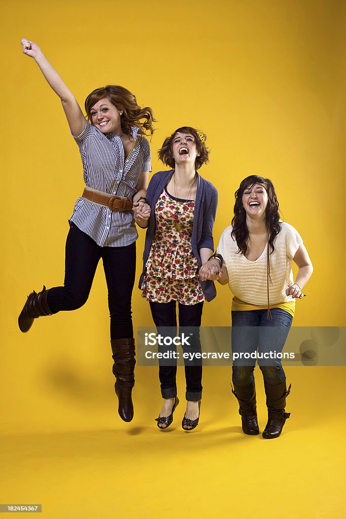 young female portraits young adult female portraits on yellow background jumping (photos professionally retouched - Photoshop) - motion blur intentional Adult Stock Photo