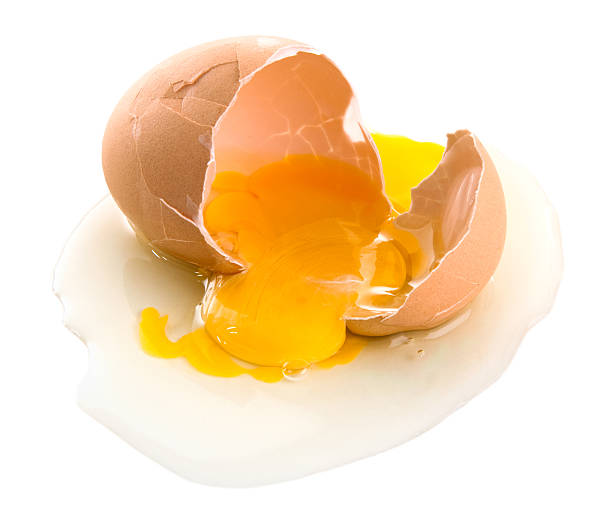 istock Cracked brown eggs with yolk spilling out 182454468