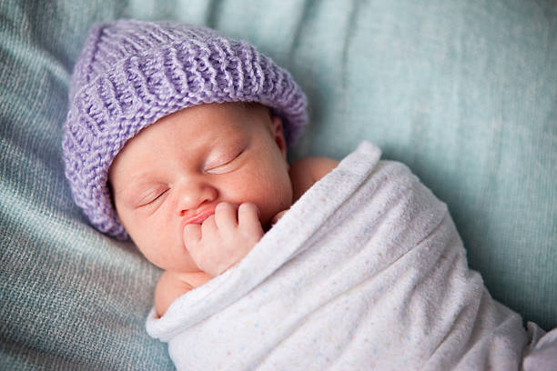 istock Newborn Baby Sleeping Peacefully Wrapped in Blanket 182454704