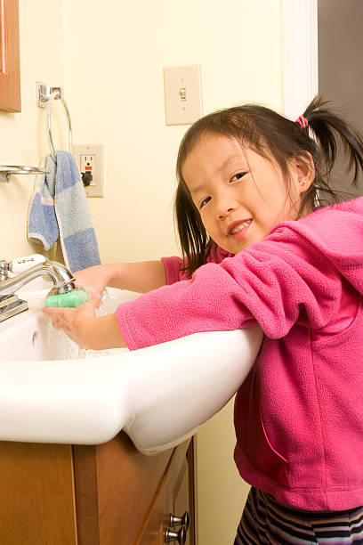 istock Preschooler washing hands 182454835