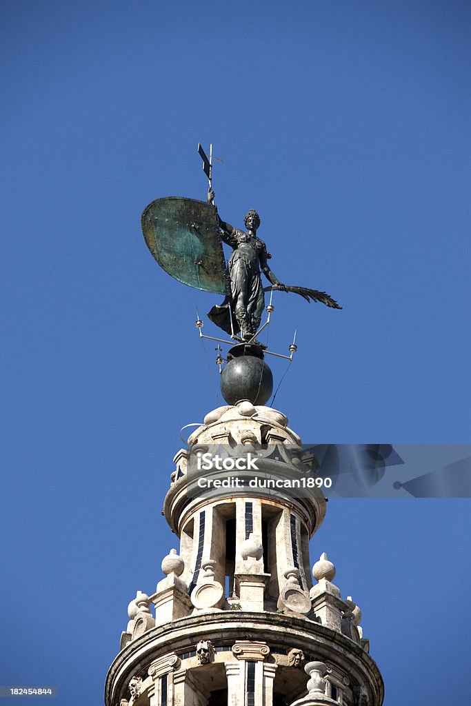 The Giraldillo Seville Spain "The Giralda is the bell tower of the Cathedral of Seville in Seville, Spain, one of the largest churches in the world and an outstanding example of the Gothic and Baroque architectural styles. Is topped with a statue, known locally as El Giraldillo, representing Faith." Architectural Feature Stock Photo