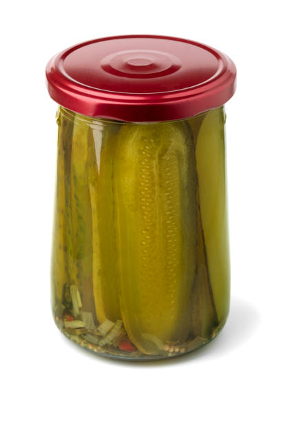 istock Glass jar with sliced gherkins close up on white background 1824558865