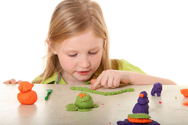 istock girl looking at clay art 182456712
