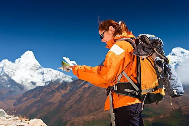 istock Female trekker looking at map, Ama Dablam on background 182456990