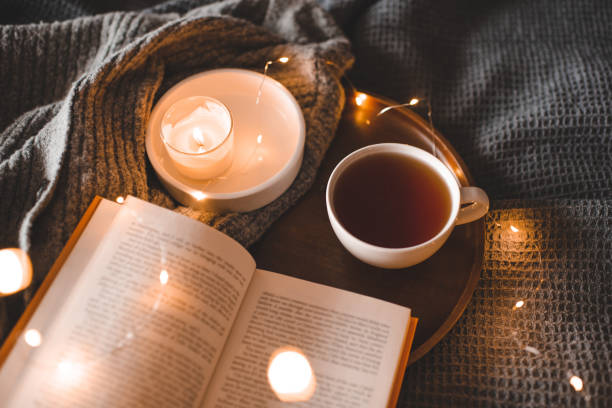 istock Cozy home atmosphere with cup of tea with book 1824576190