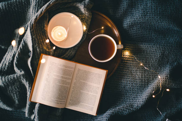 istock Cozy home atmosphere with cup of tea with book 1824576210