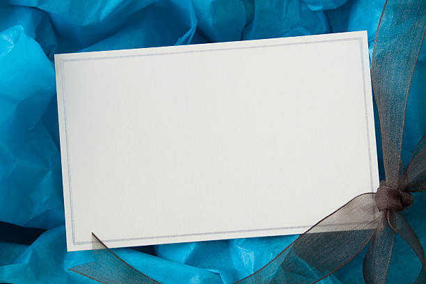 Beautiful blue silk ribbon with paper card on a color background