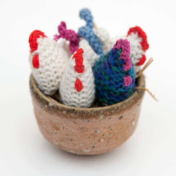 istock Knitted hens and cock in a bowl 182458286