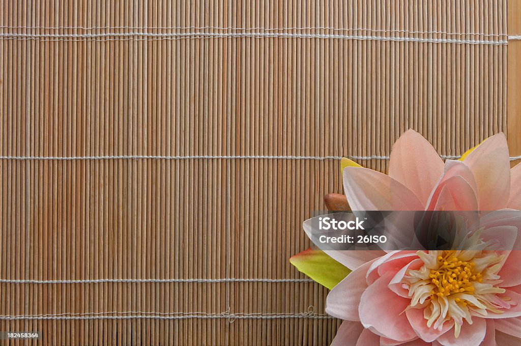 Peaceful Silence, Lotus Flower on the Bamboo with Copyspace At the SPA, a top view with a pink Nymphaea/Lotus flower on the bamboo, with copyspace. Lotus Water Lily Stock Photo