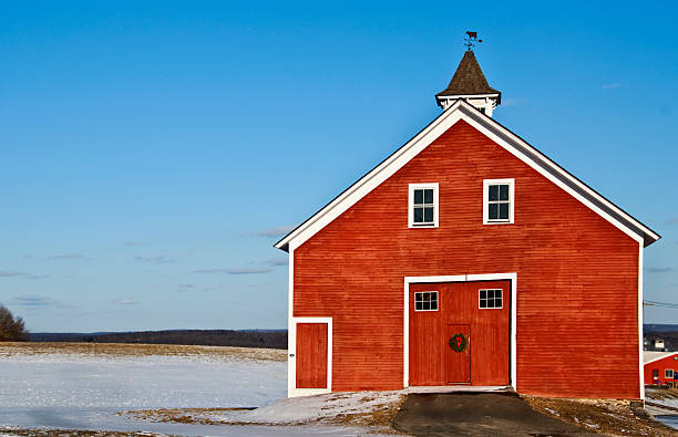 Red Dairy Barn with Wreath and Double Doors stock photo
