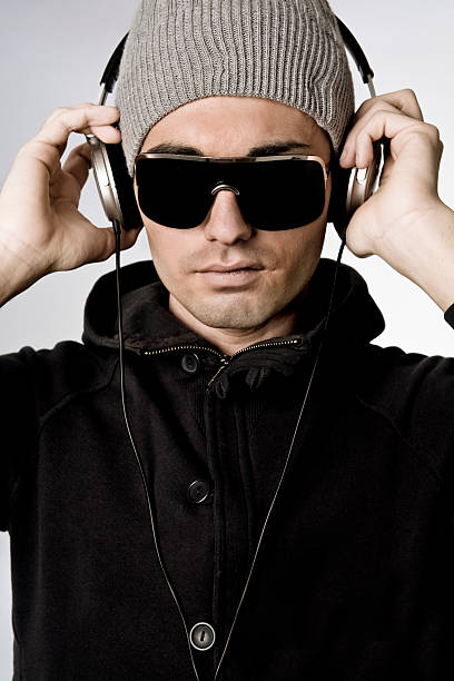 istock Dj Portrait Hand On Headphones Looking At Camera 182458434