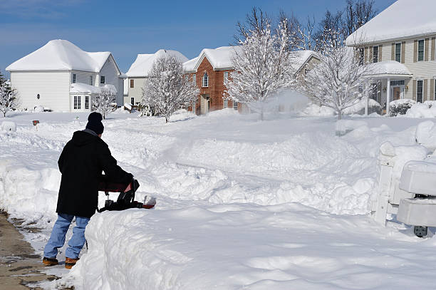 istock Man uses Snowblower after Blizzard Snow 182458578