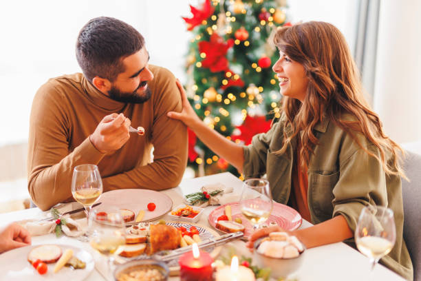 istock Couple having Christmas dinner with friends at home 1824588156