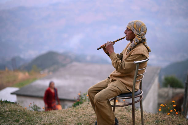 In this mesmerizing photo, a local Himachali man serenades the mountains, creating a symphony of tranquility as he plays a flute during the golden hues of sunset. Dressed in traditional Himachali attire, the flutist stands against the backdrop of the awe-inspiring mountains, embodying a profound connection to nature and heritage.