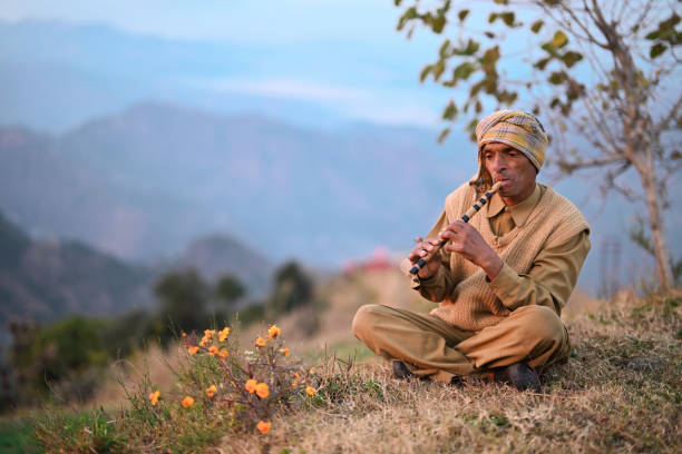 In this mesmerizing photo, a local Himachali man serenades the mountains, creating a symphony of tranquility as he plays a flute during the golden hues of sunset. Dressed in traditional Himachali attire, the flutist stands against the backdrop of the awe-inspiring mountains, embodying a profound connection to nature and heritage.