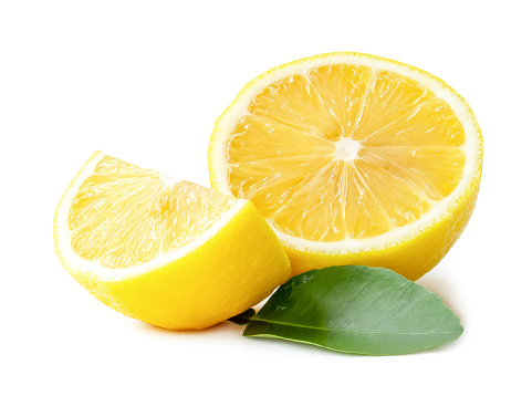 Fresh yellow lemon half with quarter and leaves is isolated on white background with clipping path.