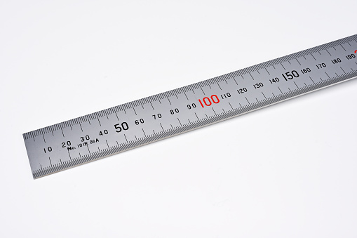 Human hand holding a measuring tape. Isolated on a white background.