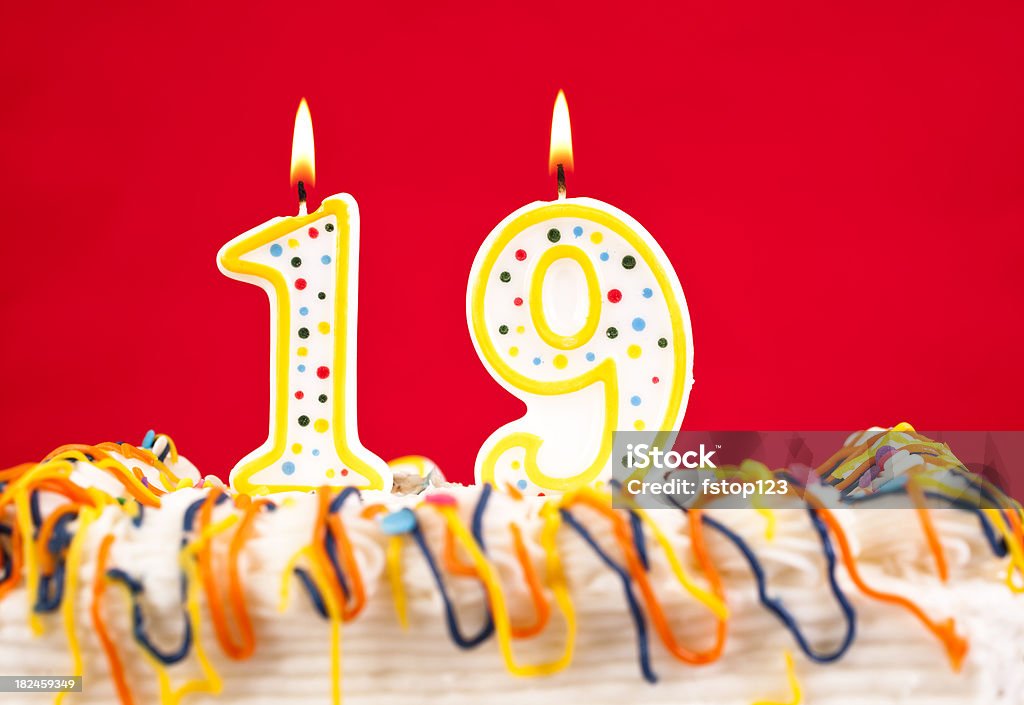 Decorated cake  with number 19 burning candles Decorated cake  with number 19 burning  candles.  Red background    Birthday Stock Photo