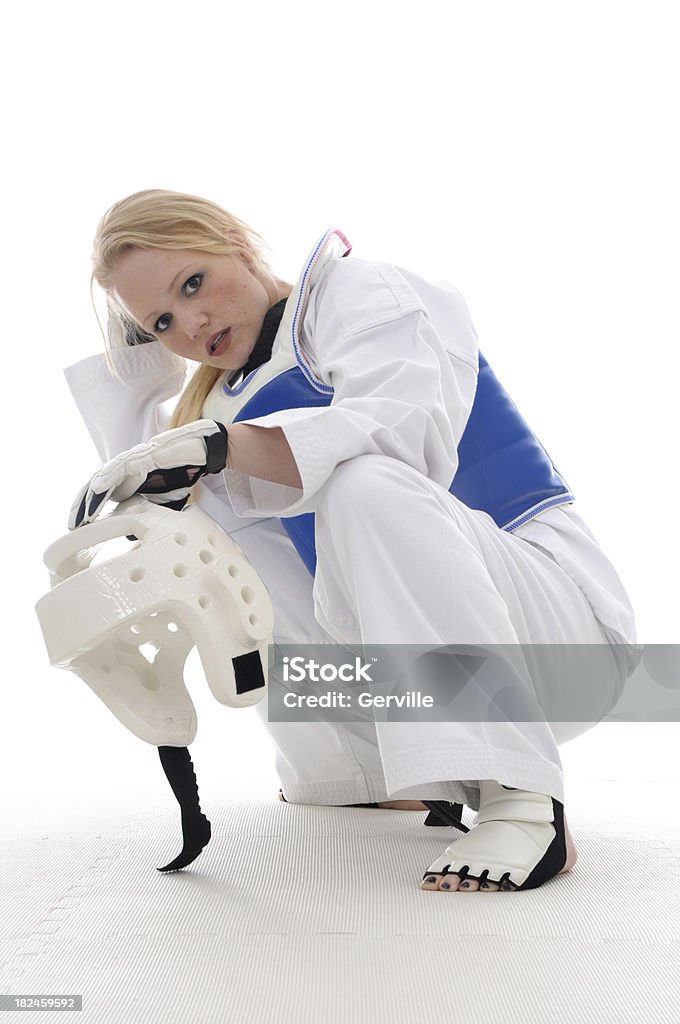 Sparring class break Martial artist taking a break in sparring padding. Blond Hair Stock Photo